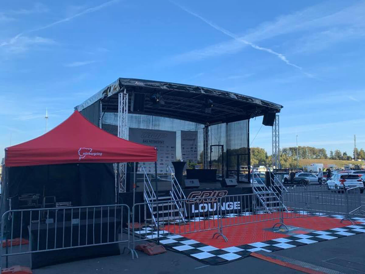 Mobile stage with a folding tent on a race circuit